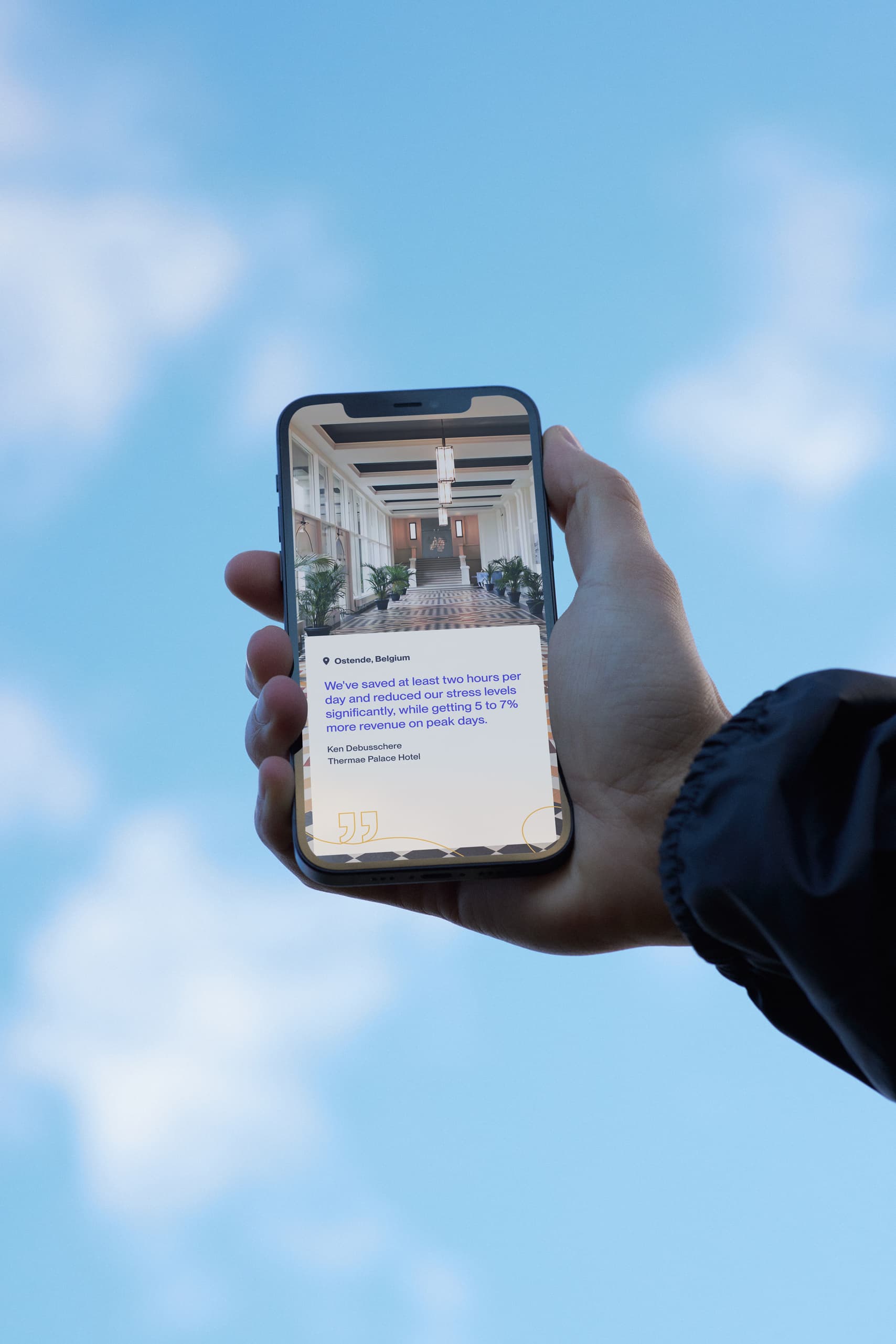 Hand with phone with blue sky in the back